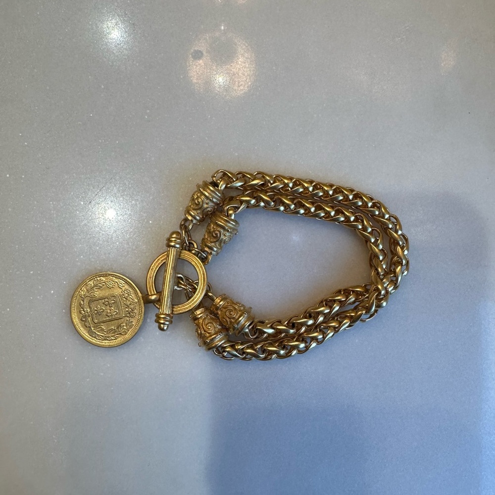 Gold bracelet with coin charm and double chain